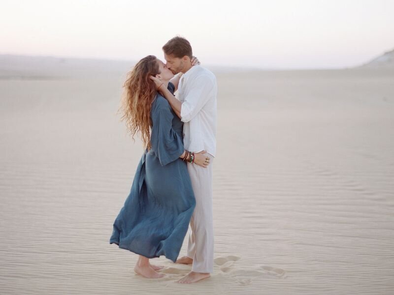 Britton and Carolee kissing in the Sahara